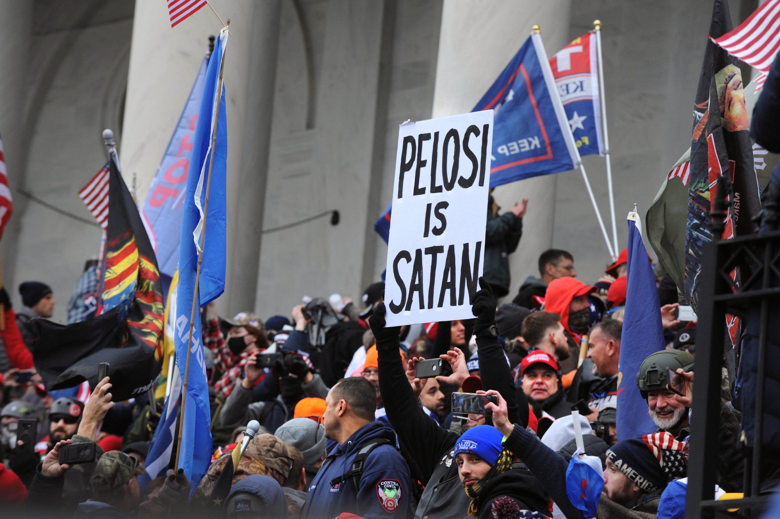 "Pelosi Is Satan" banner on Capitol steps.