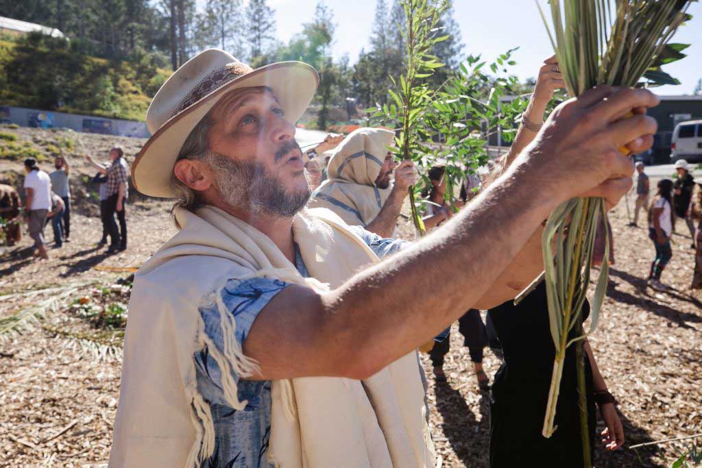 Rabbi Golden with a lulav. Photo credit: Darren Miller for Wilderness Torah.