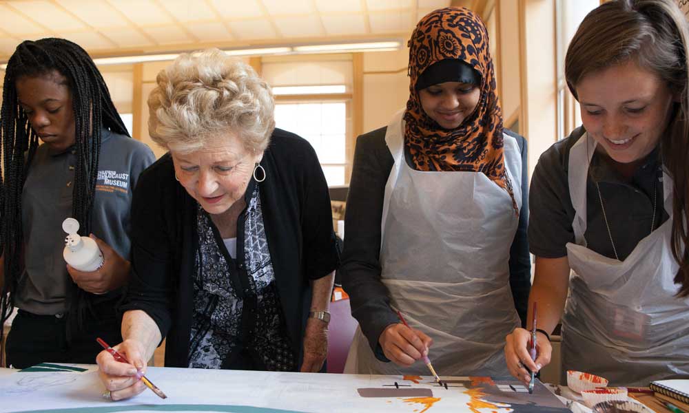 Holocaust survivor Halina Litman Yasharoff Peabody, a volunteer at the USHMM, works with students participating in the museum’s Art &amp; Memory program. Holocaust education in action.