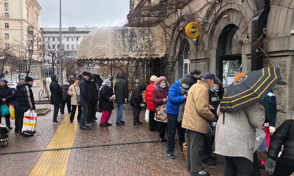 People in Kyiv gather around a market during war