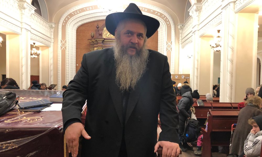 Rabbi Moshe Azman stands in his synogogue