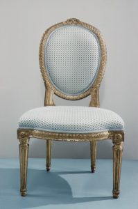 a blue and golden chair