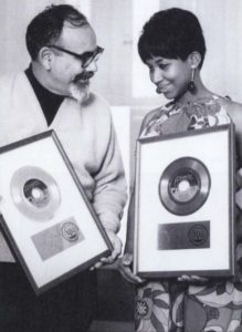 Phil Chess and Aretha Franklin holding record plaques