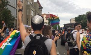 a man wears a yarmulke at a Pride event