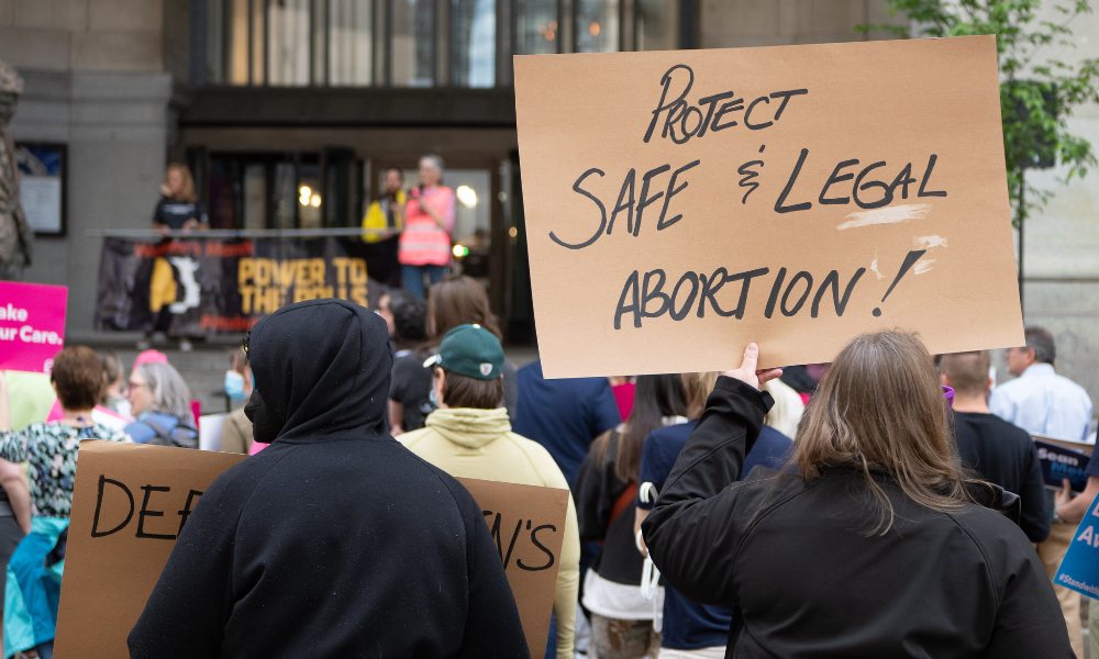 Protestors hold up signs demanding access to abortion