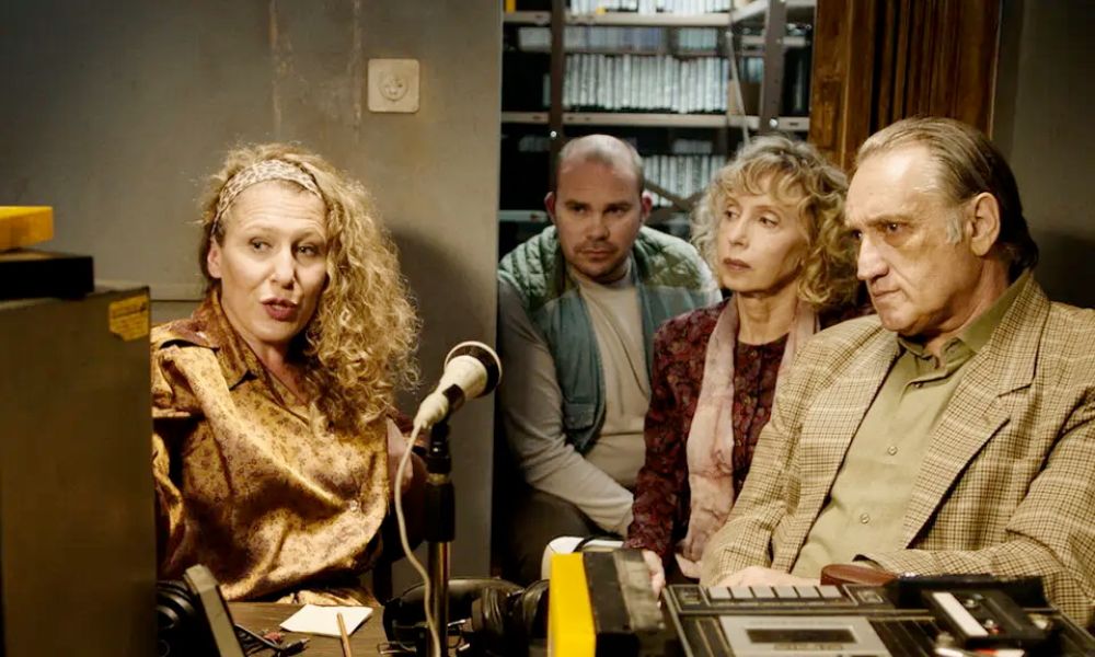 A still from the film Golden Voices showing the main cast in a recording studio.