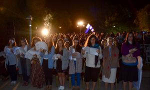 A group of young women pray selihot outside at night in Israel.