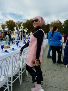Woman poses at empty Shabbat table
