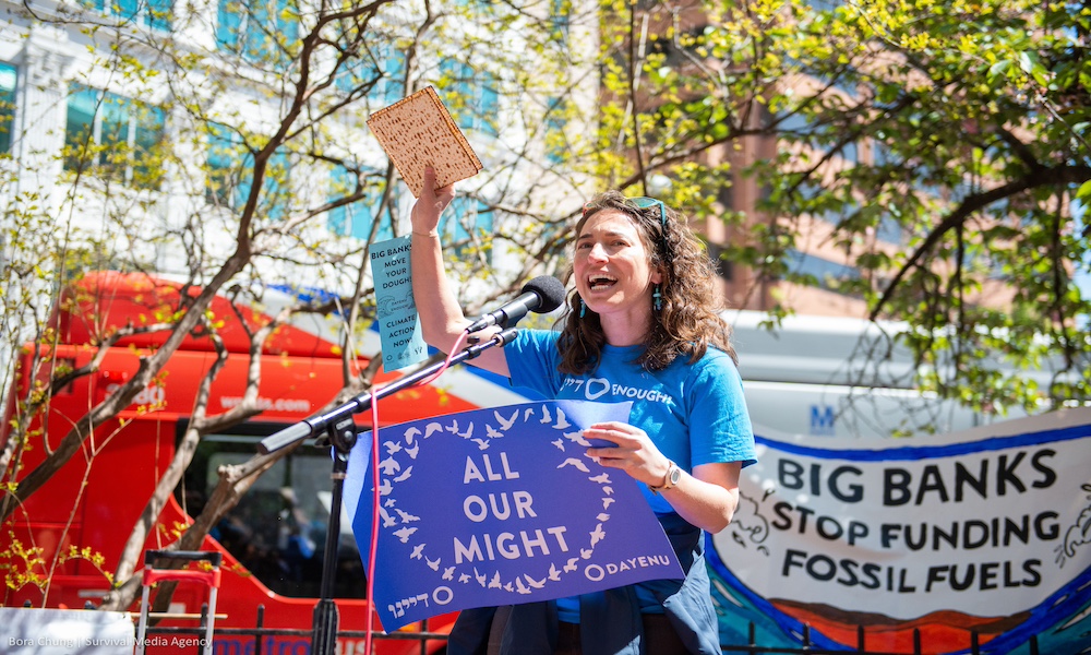 Rabbi Laura Bellows, Director of Spiritual Activism and Education, holding up matzoh at a protest in Washington, DC.