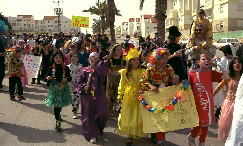 Children in a parade wearing Purim costumes