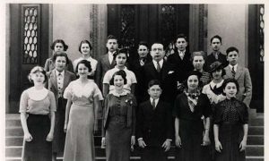 Black and white photo of confirmation students and their teacher.