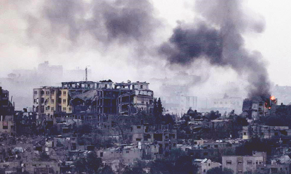 A skyline of destroyed buildings. Smoke in the sky billows from a fire on the right.