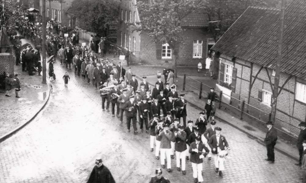 A band marches in front of the author's family's house in this photo taken in 1930.