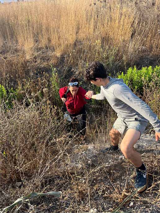 son helps mother out of ditch