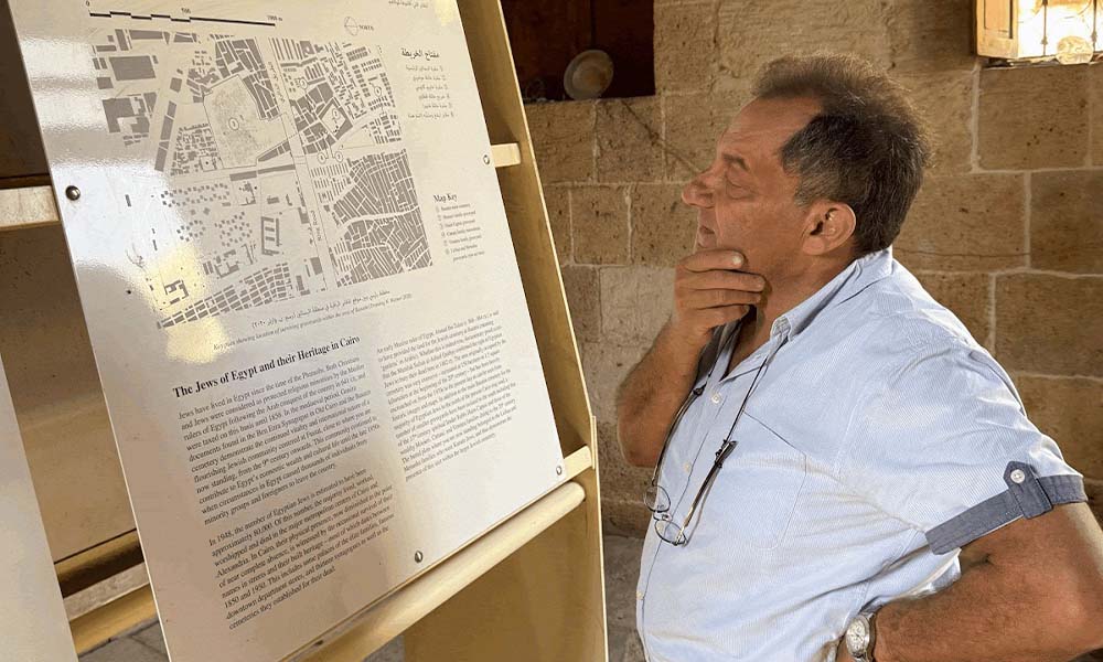Sami Ibrahim inspects a map of restored Karaite tombs.