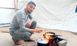 Basil Helles cooking in his tent in Gaza